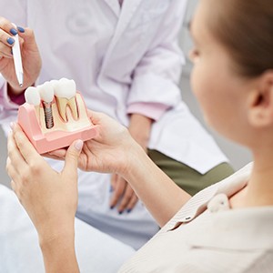 a patient in Frisco learning how dental implants work 