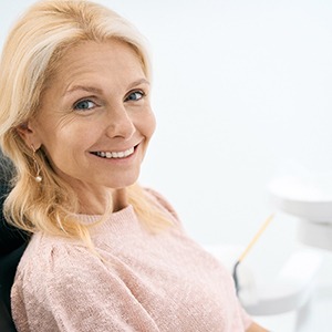 a patient smiling after getting dental implants in Frisco