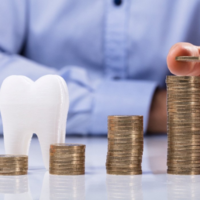 Coins next to a tooth