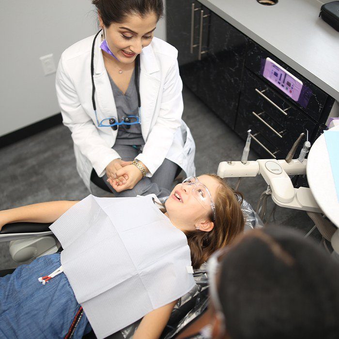 Doctor Kraipak talking to young patient about tooth-colored fillings