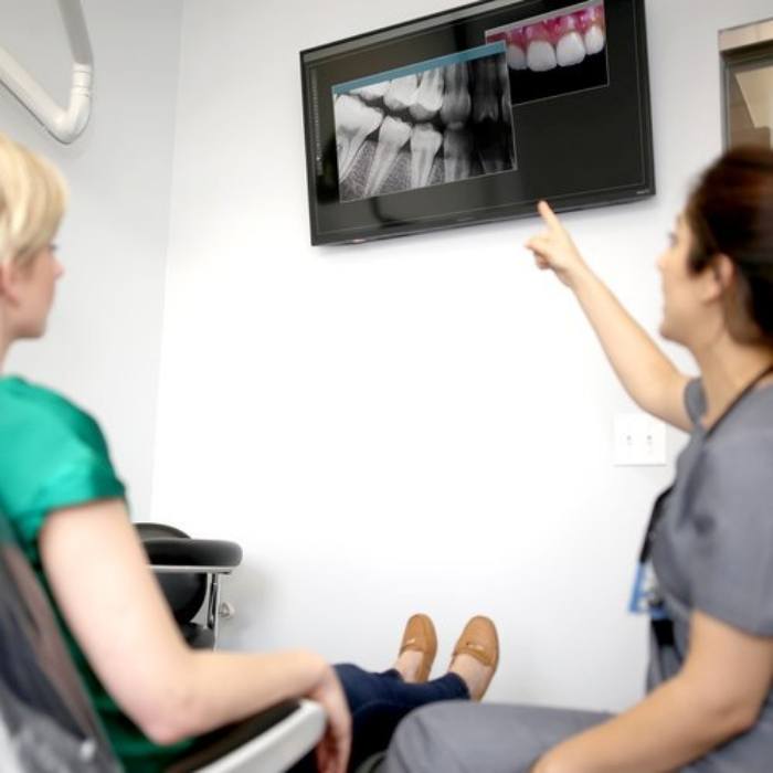 Dentist and patient looking at x-rays and dental restoration design