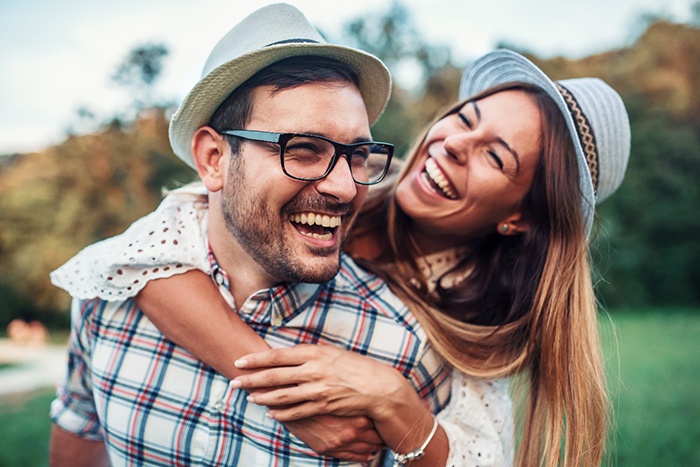 a couple smiling about being good candidates for dentures