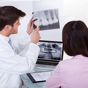 Emergency dentist in Frisco explaining an X-ray to a patient