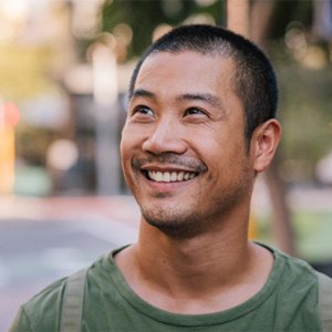 Man smiling on street