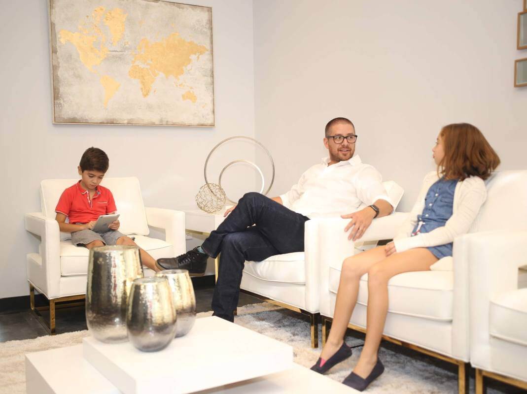 Father and two children in Frisco dental office waiting room