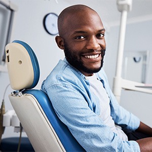 Man sitting in dental chair smiling