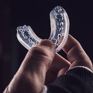 person holding a mouthguard