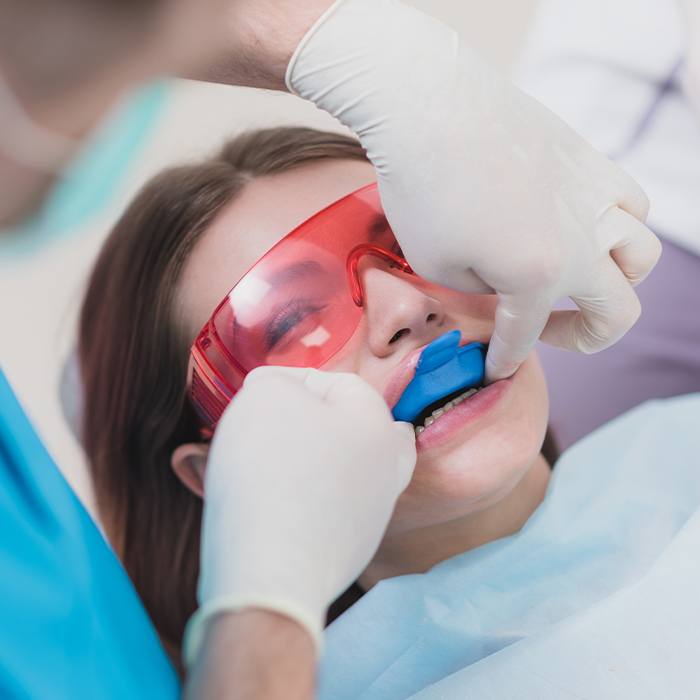 Woman receiving fluoride treatment