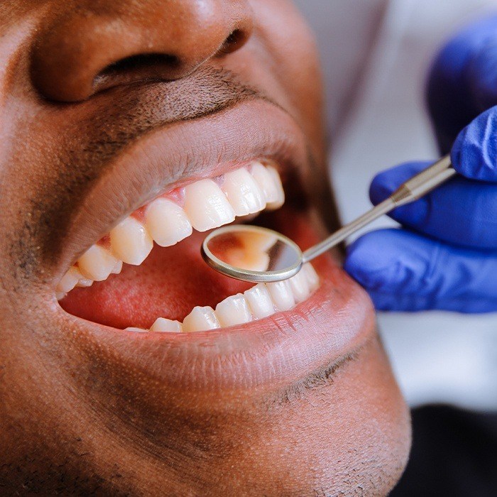 Man receiving oral cancer screening