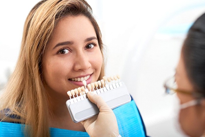 young woman getting veneers in Frisco, TX