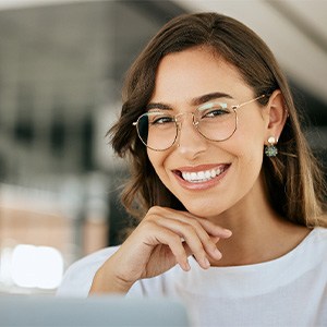Woman with glasses smiling in office
