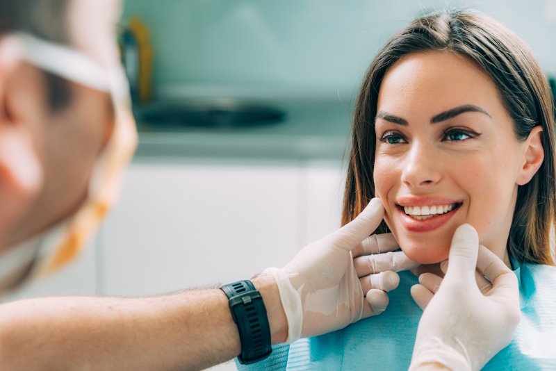 Cosmetic dentist with smiling patient