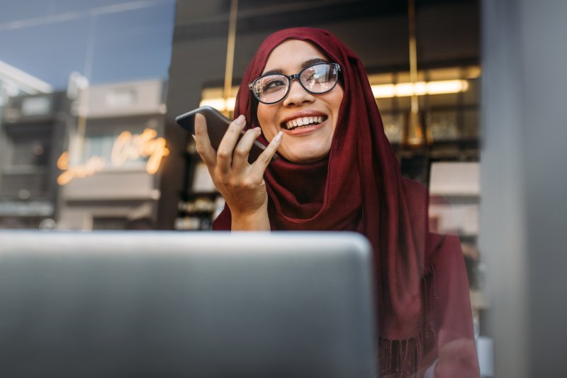 Woman using laptop to look for dentist