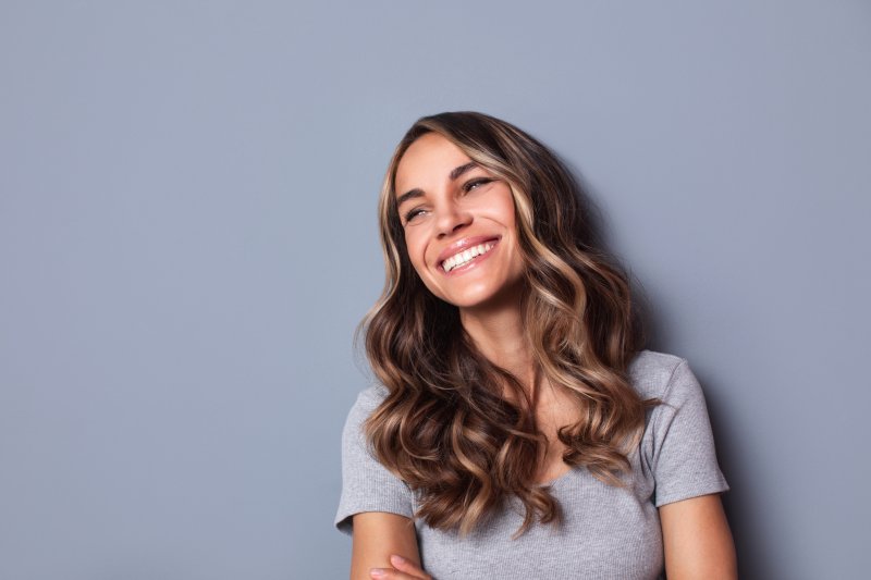 Woman smiling with porcelain veneers