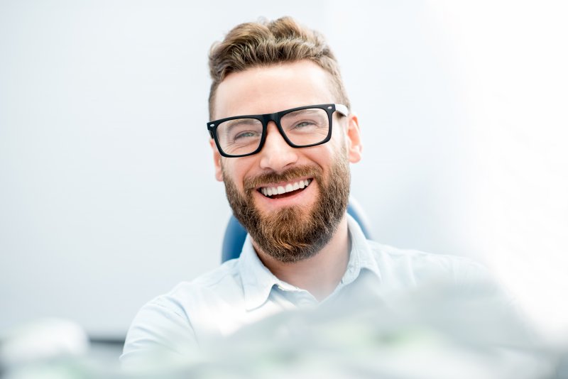 young man smiling in dental chair