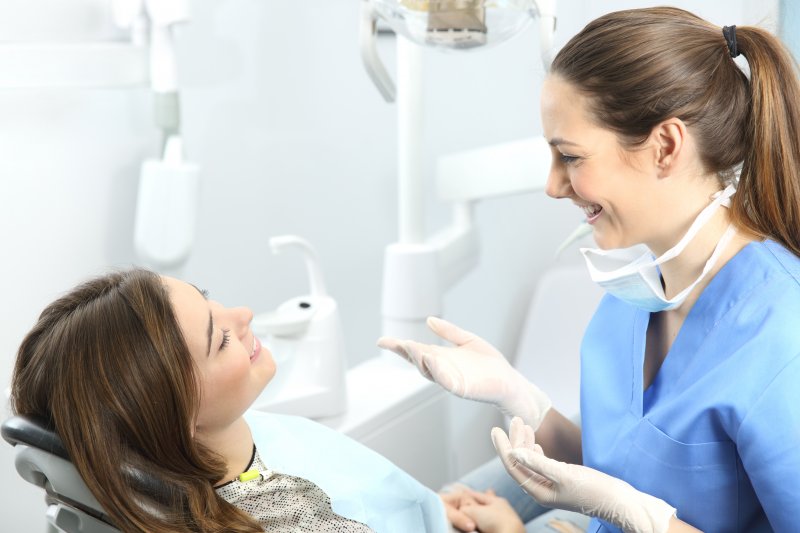 woman learning about the benefits of porcelain veneers in Frisco