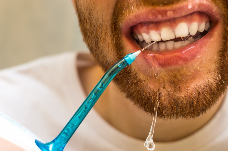 man using Waterpik in Frisco