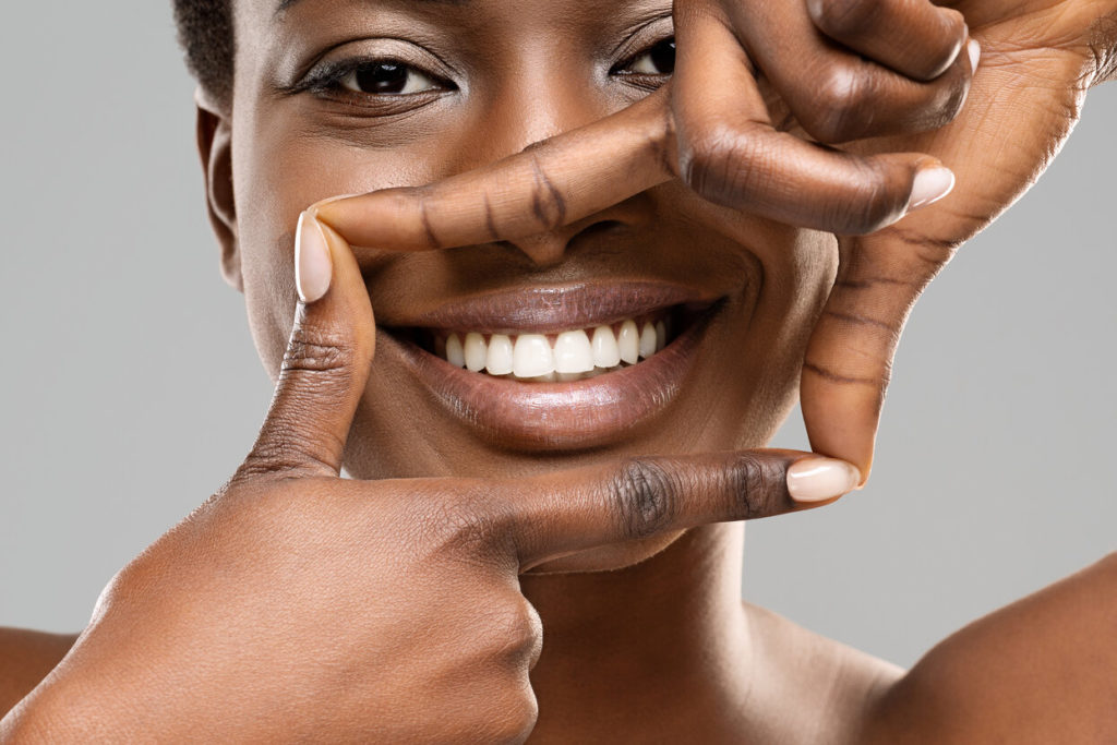 smiling patient after getting a smile makeover in Frisco