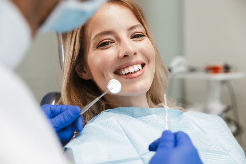 woman smiling during dental checkup in Frisco