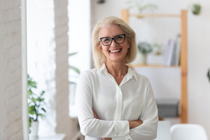 Senior woman with glasses giving a confident grin