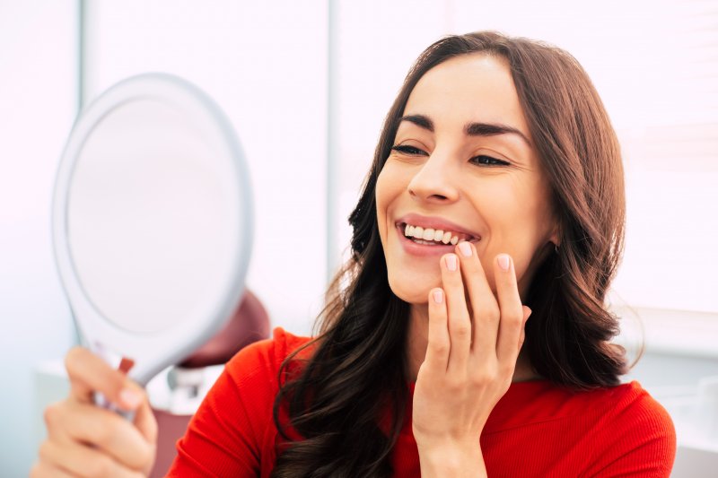 A woman smiling after her cosmetic dentistry treatments