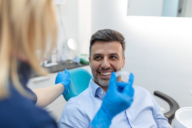 A man smiling after his teeth whitening treatment