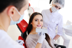 a patient smiling and admiring her veneers