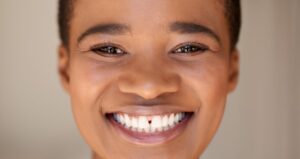 Young woman with gap in teeth.